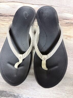 OluKai Black Footbed Flip Flops with Beige Striped Thong